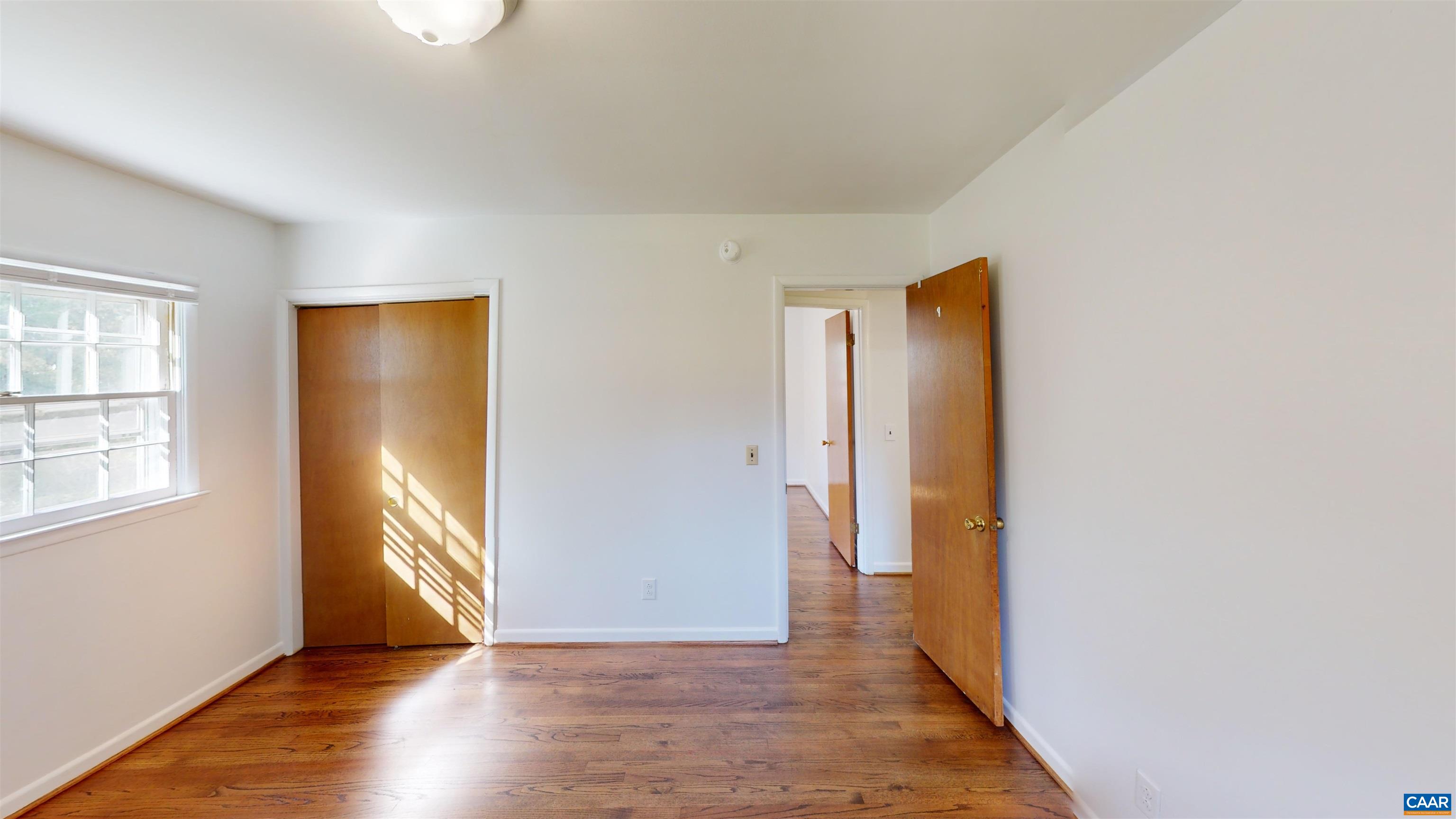 3595 Garth Road Charlottesville, VA 22901 - Photo 9 of 14 an empty room with wooden floor and windows