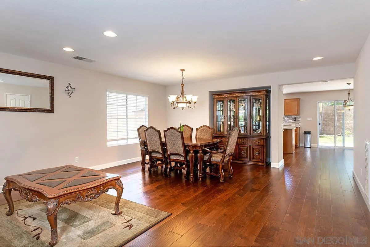 304 River Ranch Way Oceanside, CA 92057 - Photo 13 of 44 a living room with furniture dining table and a chandelier