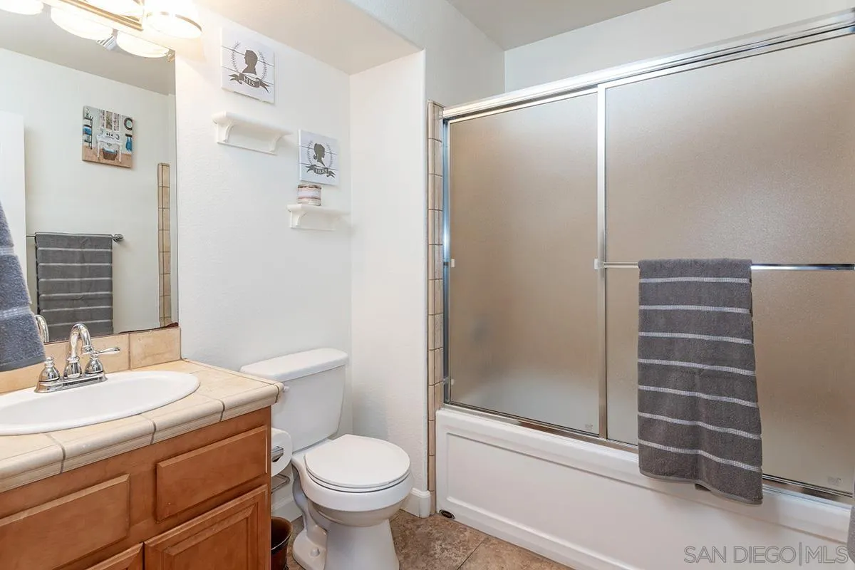 304 River Ranch Way Oceanside, CA 92057 - Photo 34 of 44 a bathroom with a granite countertop sink toilet and shower
