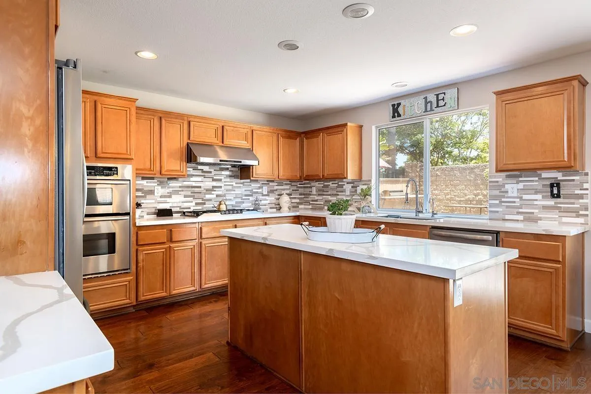 304 River Ranch Way Oceanside, CA 92057 - Photo 5 of 44 a kitchen with stainless steel appliances granite countertop a stove a sink and a refrigerator