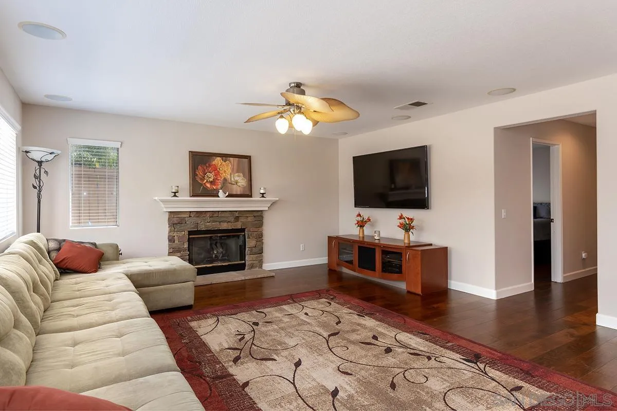 304 River Ranch Way Oceanside, CA 92057 - Photo 10 of 44 a living room with furniture a flat screen tv and a fireplace