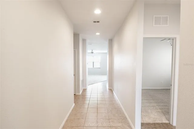 a view of hallway with closet and bathroom