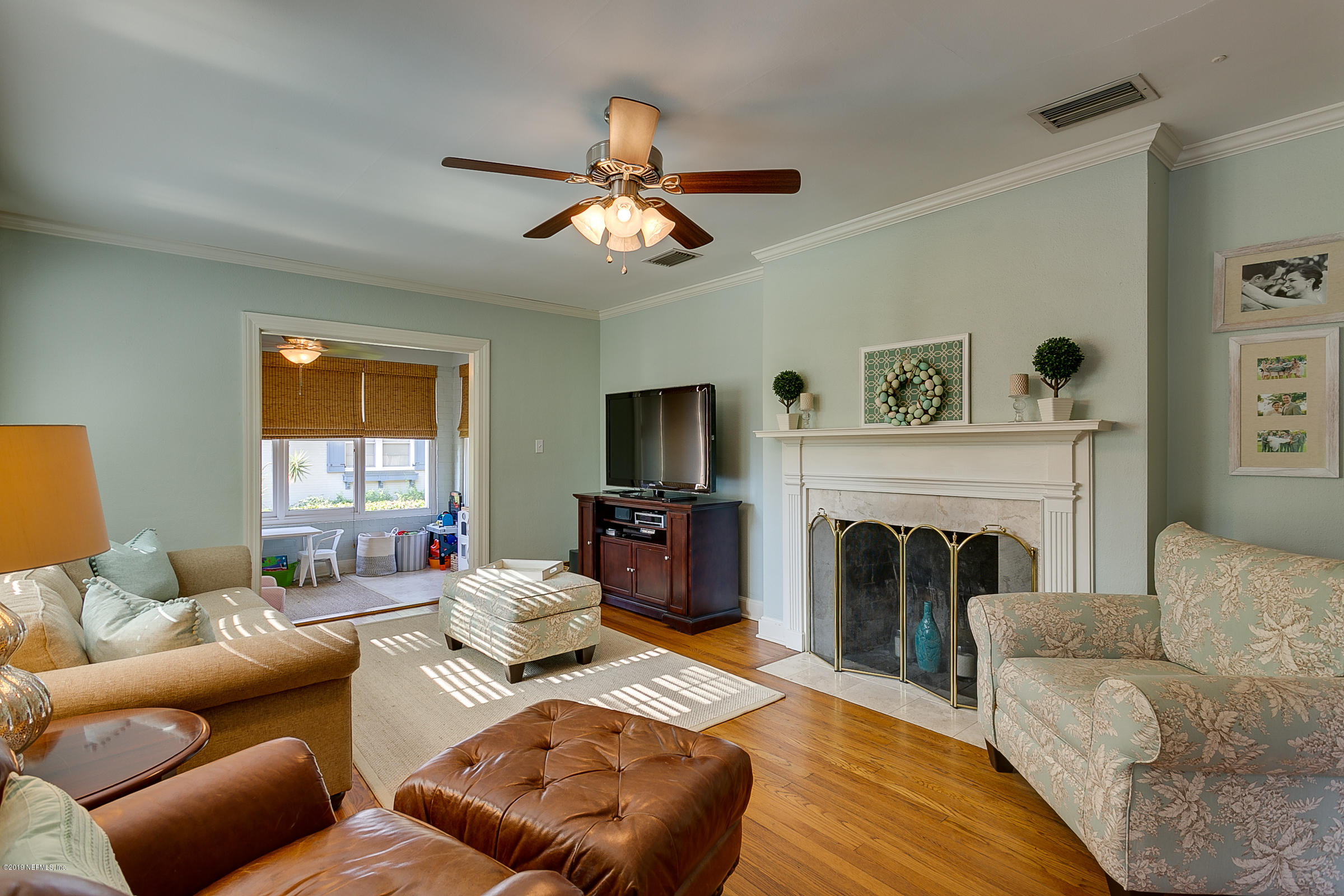 1456 Nicholson Road Jacksonville, FL 32207 - Photo 5 of 27 a living room with furniture a fireplace and a flat screen tv