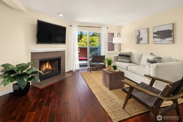 a living room with furniture a flat screen tv and a fireplace