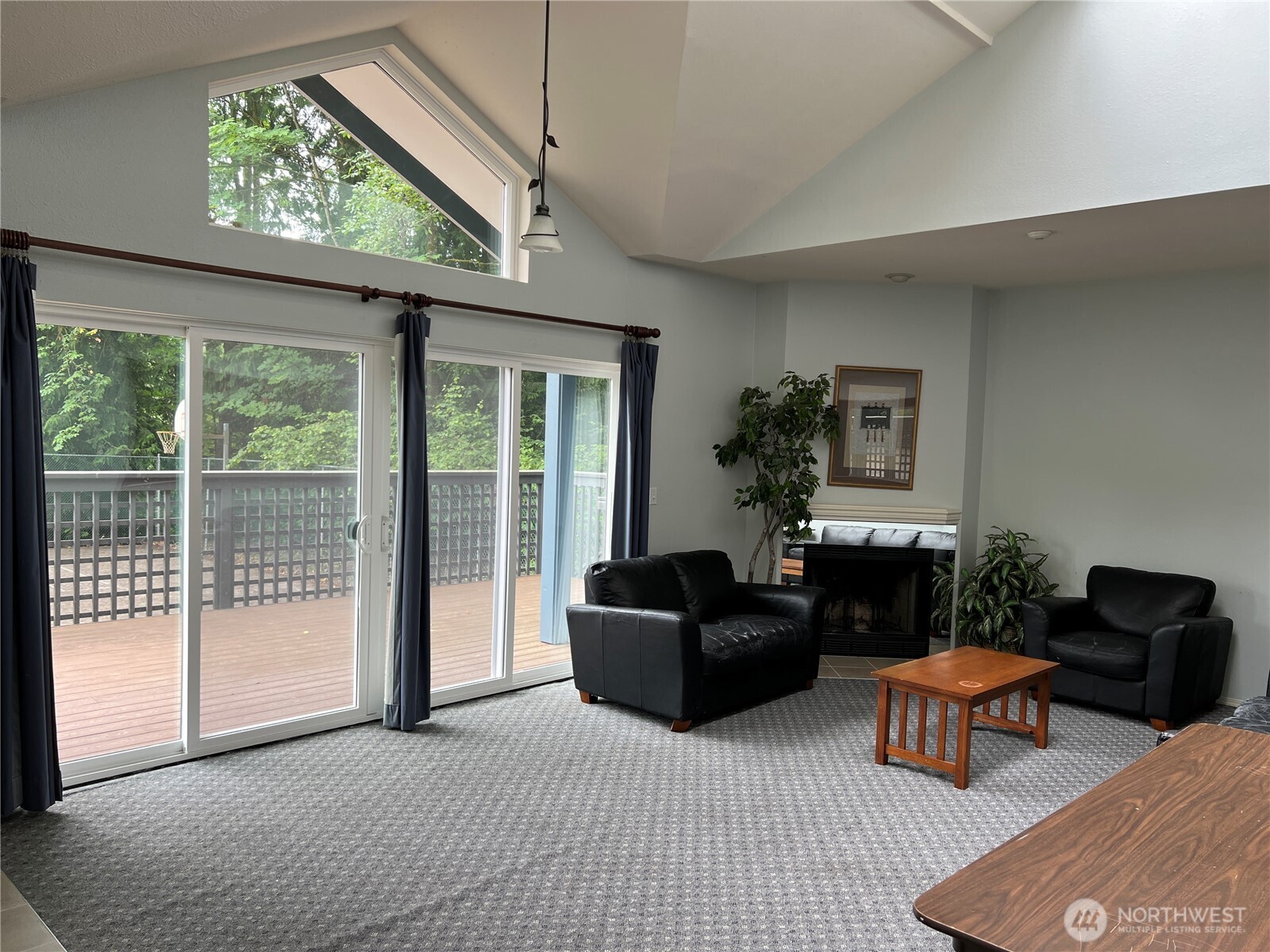 15711 Waynita Way Northeast, Unit H106 Bothell, WA 98011 - Photo 16 of 20 a living room with furniture a flat screen tv and a large window