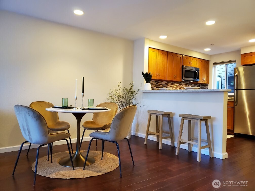 15711 Waynita Way Northeast, Unit H106 Bothell, WA 98011 - Photo 4 of 20 a view of a dining room with furniture and wooden floor
