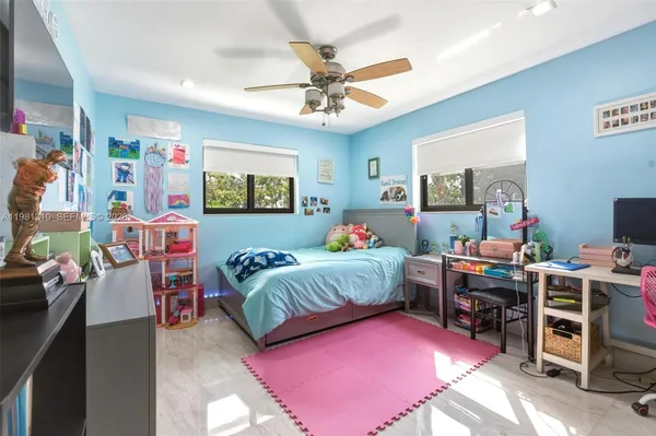 a bedroom with a bed and a desk