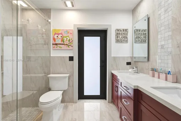 a bathroom with a granite countertop toilet sink and shower