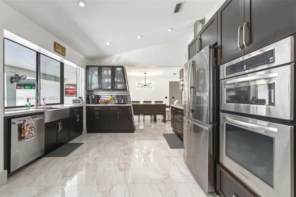 a view of a dining room with furniture and a chandelier