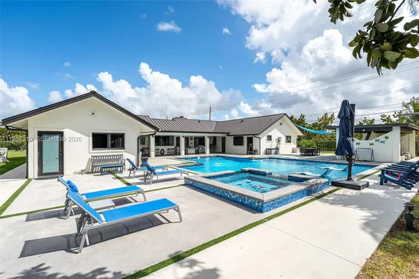 a room with pool table and windows
