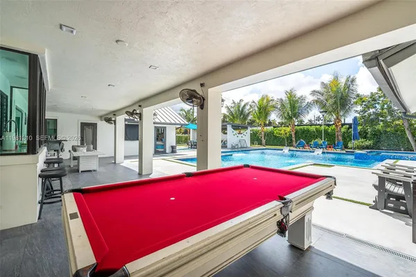 a view of a house with roof deck and sitting area