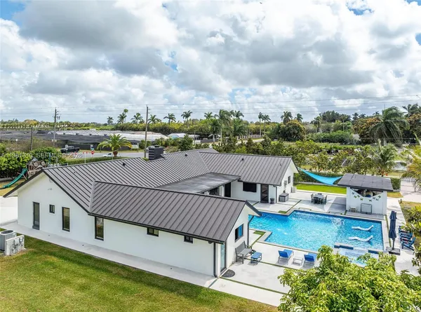 a swimming pool with outdoor seating and yard