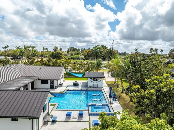 a view of a swimming pool with an outdoor space and seating area