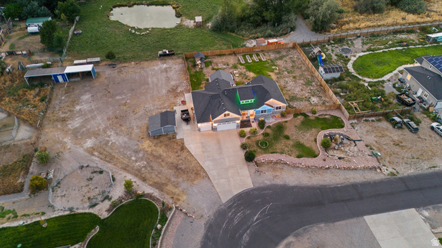 4557 North Ranch Road East Tooele, UT 84074 - Photo 43 of 43 Single-story residence with a dark shingle roof, attached garage, and a light-toned exterior