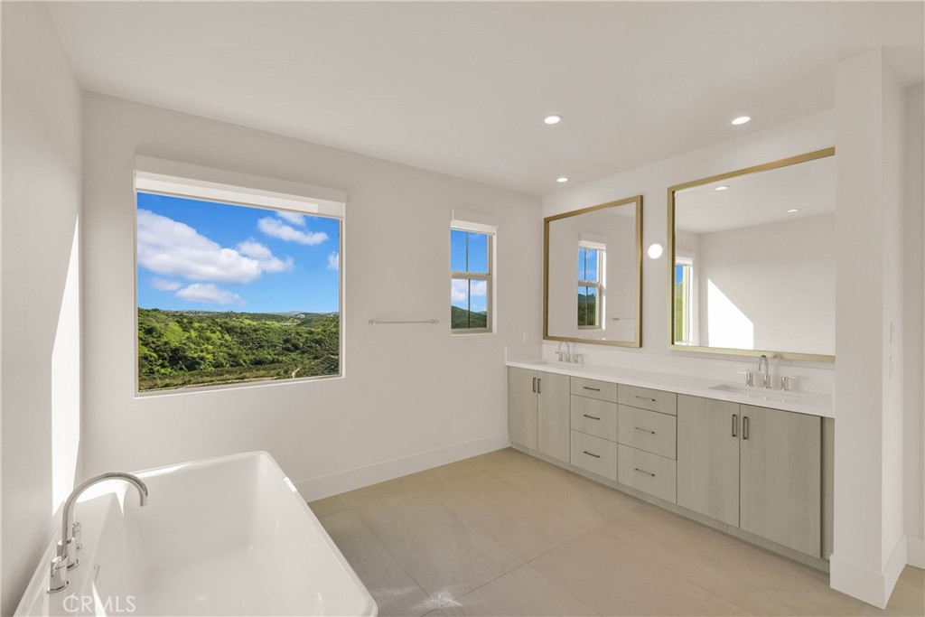 100 Mossvine Irvine, CA 92618 - Photo 12 of 26 a spacious bathroom with a granite countertop sink mirror and a large window