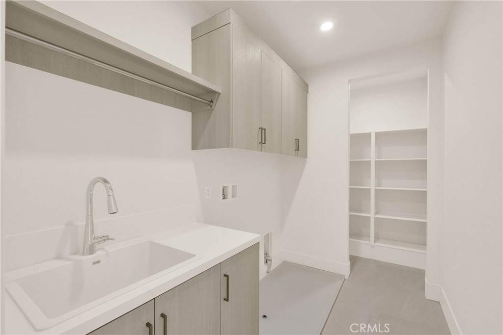 100 Mossvine Irvine, CA 92618 - Photo 18 of 26 a kitchen with a sink and cabinets