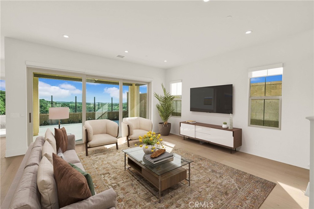 100 Mossvine Irvine, CA 92618 - Photo 6 of 26 a living room with furniture and a flat screen tv