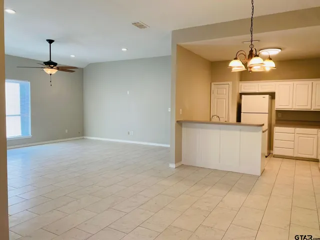 a view of a kitchen with a cabinet and a chandelier
