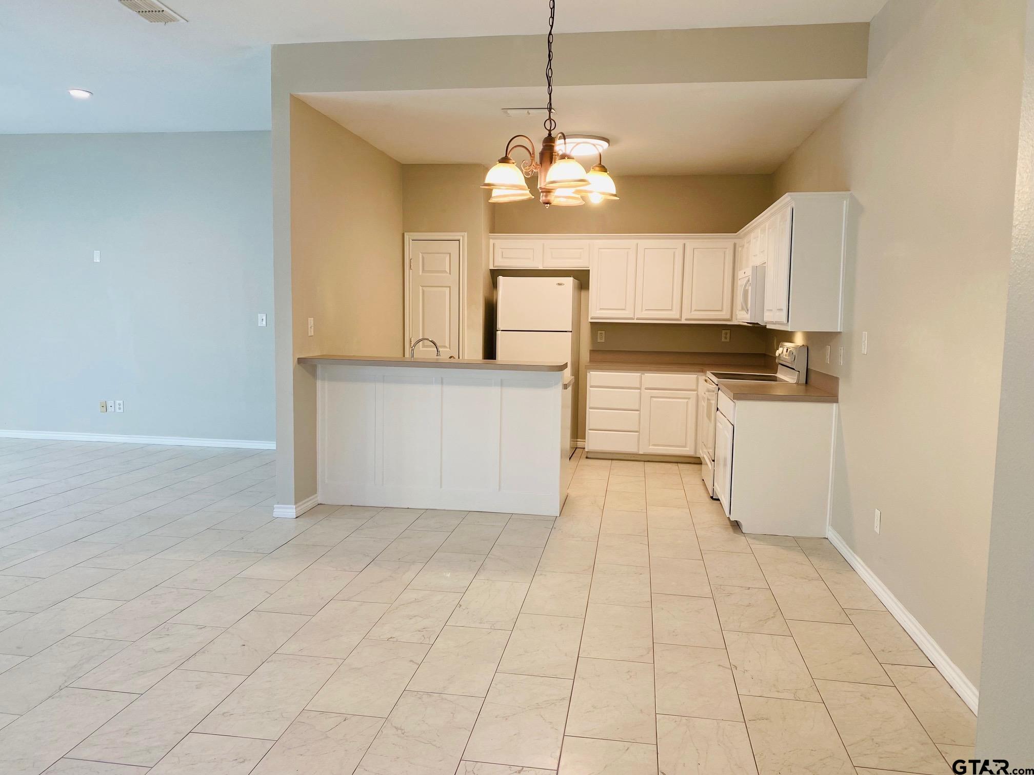 19586 FM 2493 Flint, TX 75762 - Photo 4 of 15 a kitchen with granite countertop a stove a sink and a refrigerator