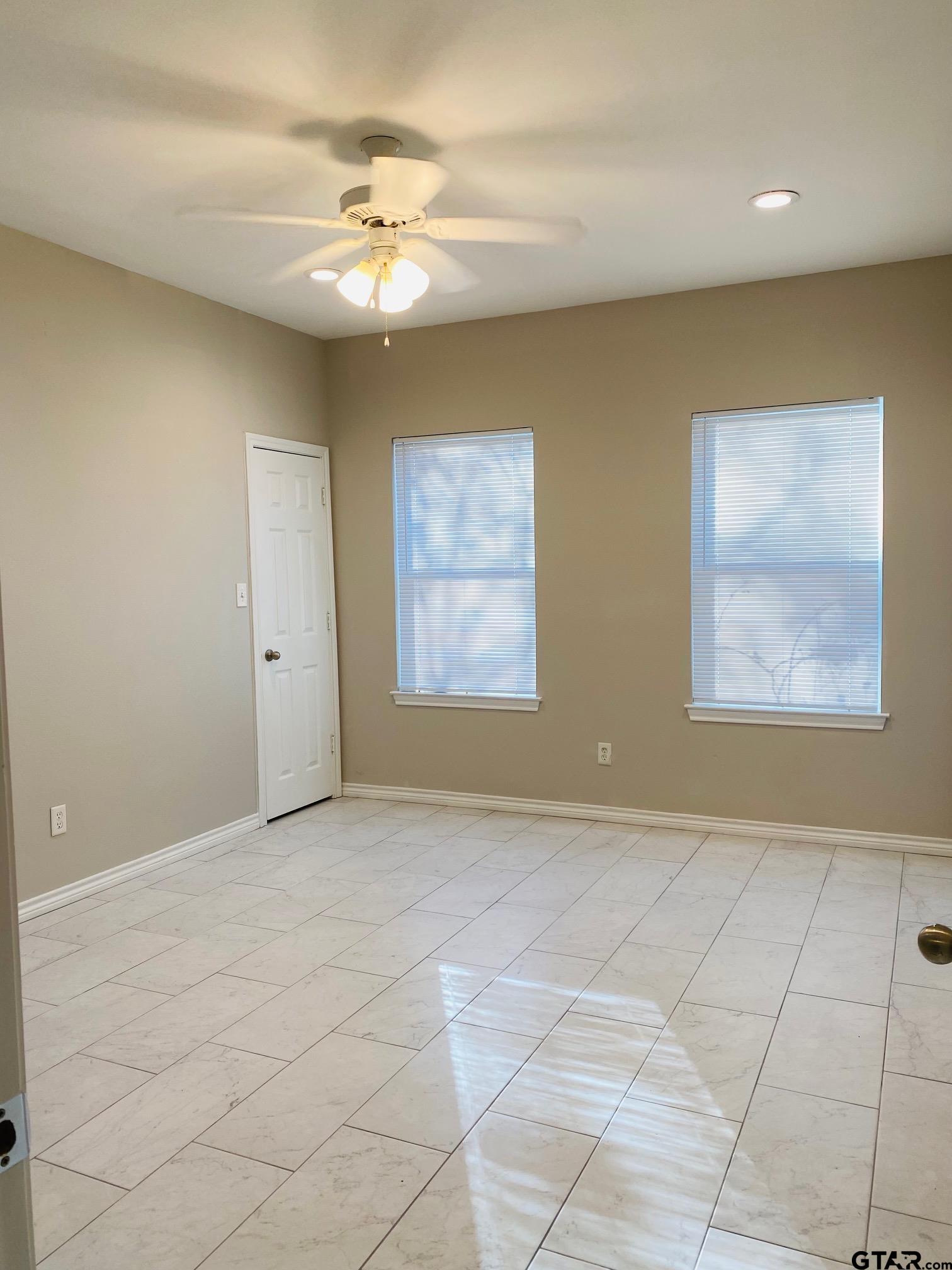 19586 FM 2493 Flint, TX 75762 - Photo 8 of 15 an empty room with windows and chandelier fan