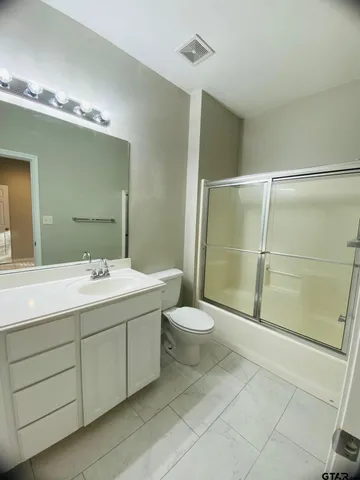 a bathroom with a toilet sink and shower