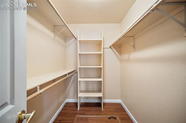 a view of walk in closet with empty racks