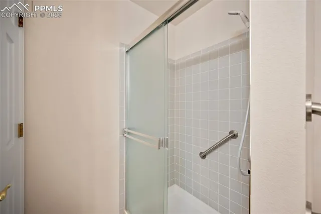 a bathroom with a glass shower door