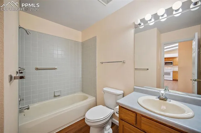 a bathroom with a sink toilet tub vanity and shower