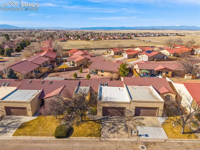 an aerial view of residential houses with outdoor space