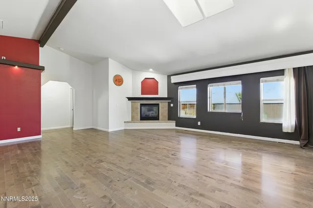 a view of livingroom with fireplace wooden floor and window