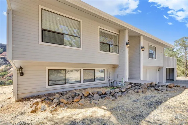 a view of a house with a yard and garage