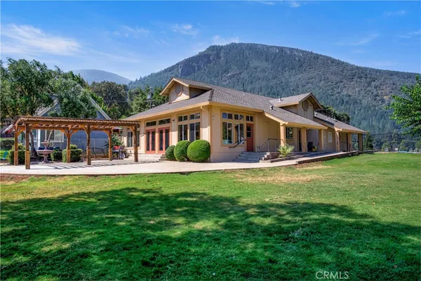 a front view of a house with swimming pool having outdoor seating
