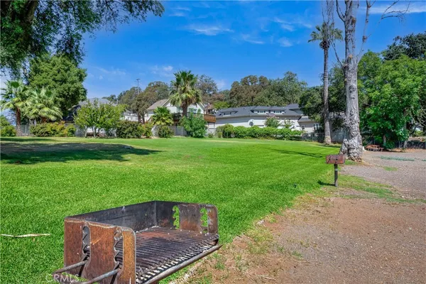 a view of a yard with a house in the background