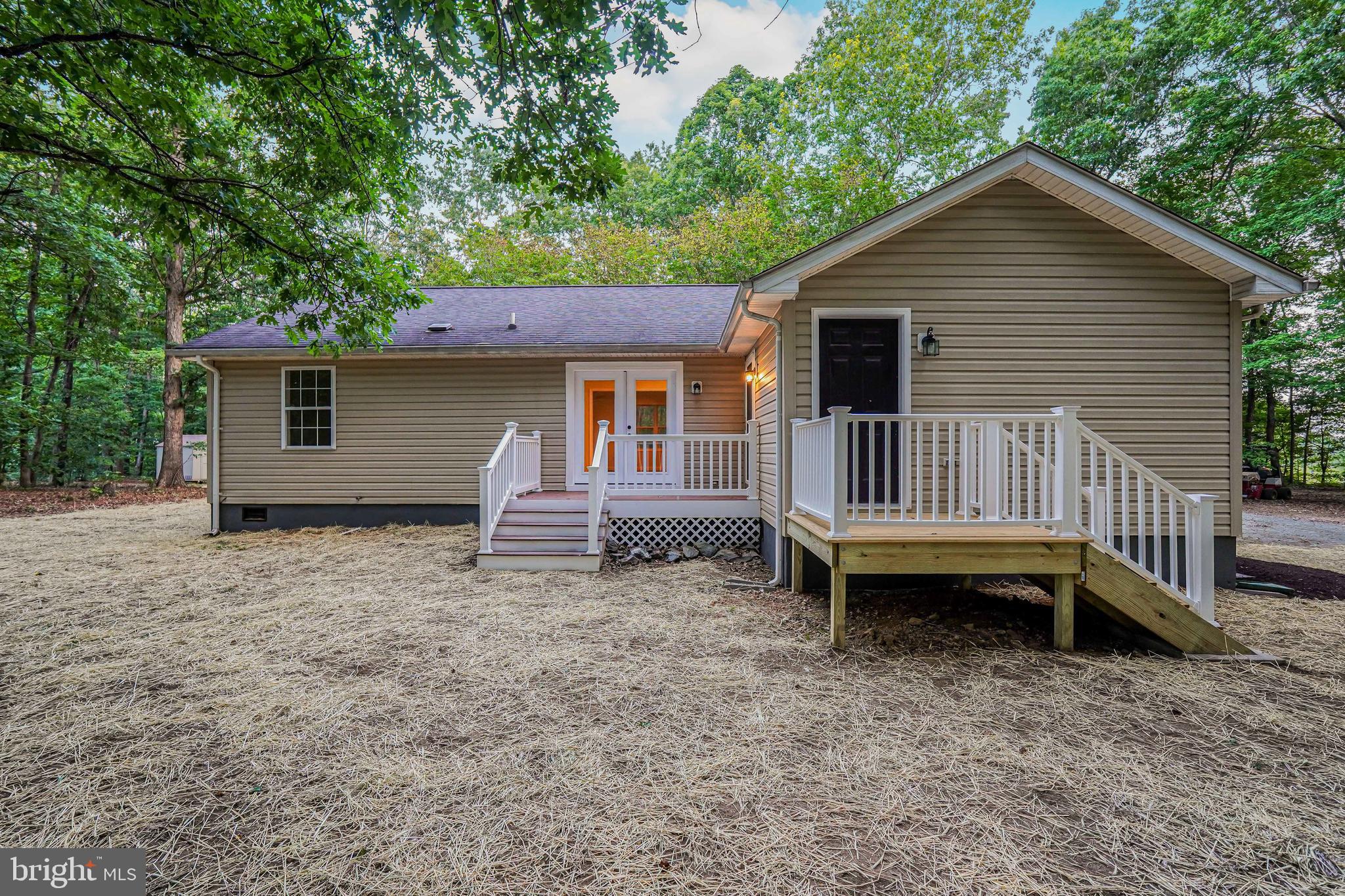767 Loving Road Zion Crossroads, VA 22942 - Photo 26 of 33 a backyard of a house with barbeque oven table and chairs