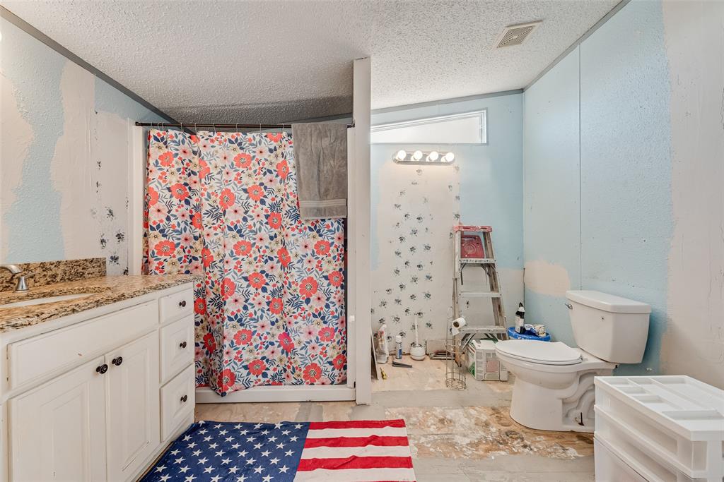 501 Billings Road Tolar, TX 76476 - Photo 14 of 22 a bathroom with a sink toilet and shower