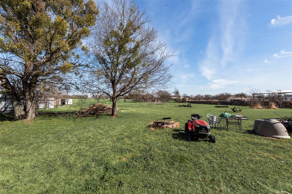 501 Billings Road Tolar, TX 76476 - Photo 20 of 22 a view of a house with a backyard