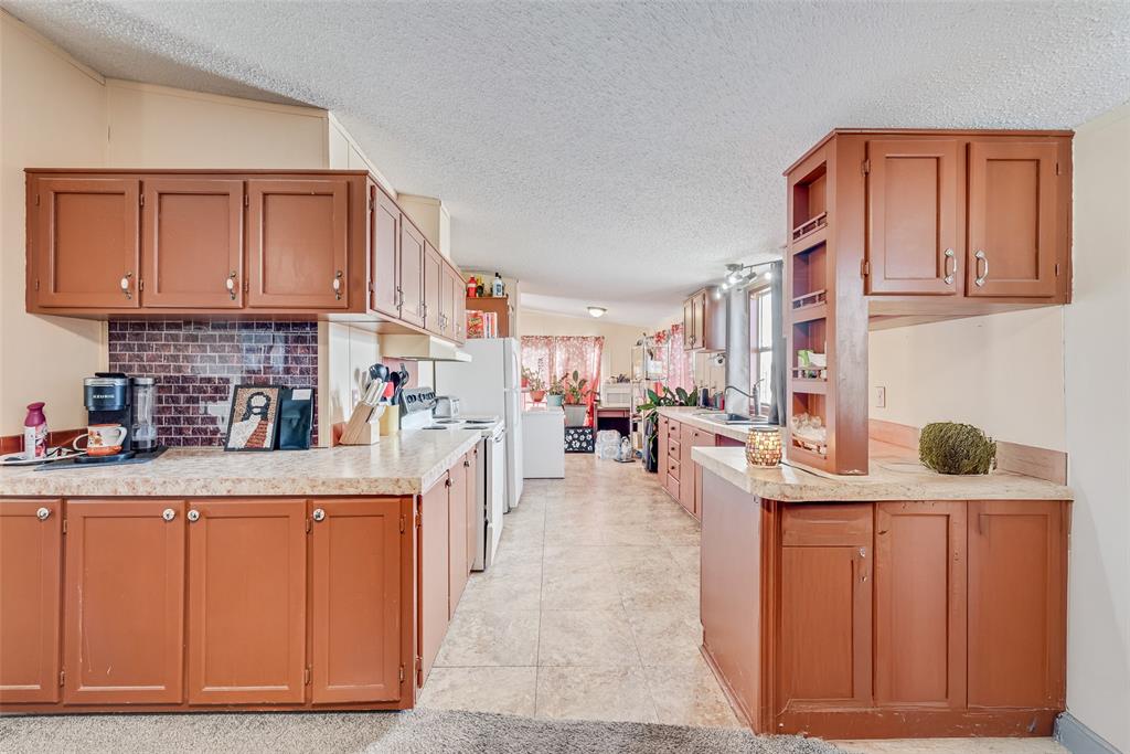 501 Billings Road Tolar, TX 76476 - Photo 5 of 22 a kitchen with cabinets and chairs