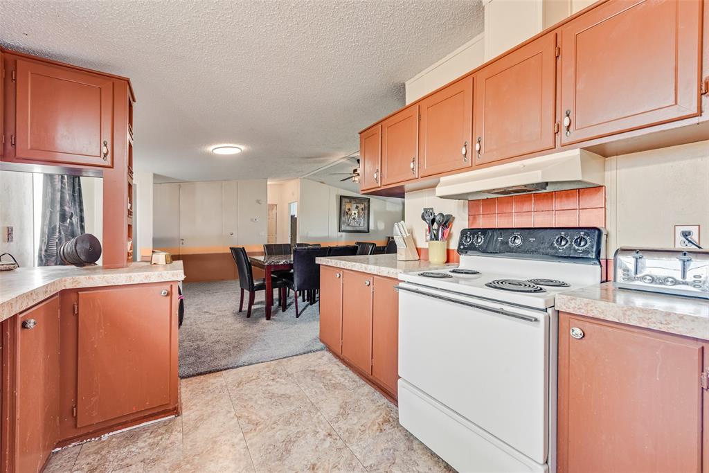 501 Billings Road Tolar, TX 76476 - Photo 8 of 22 a kitchen with stainless steel appliances granite countertop a refrigerator sink and cabinets