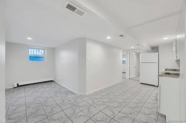 a kitchen with granite countertop white cabinets and white appliances