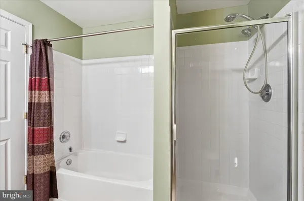 a bathroom with a shower and a bath tub