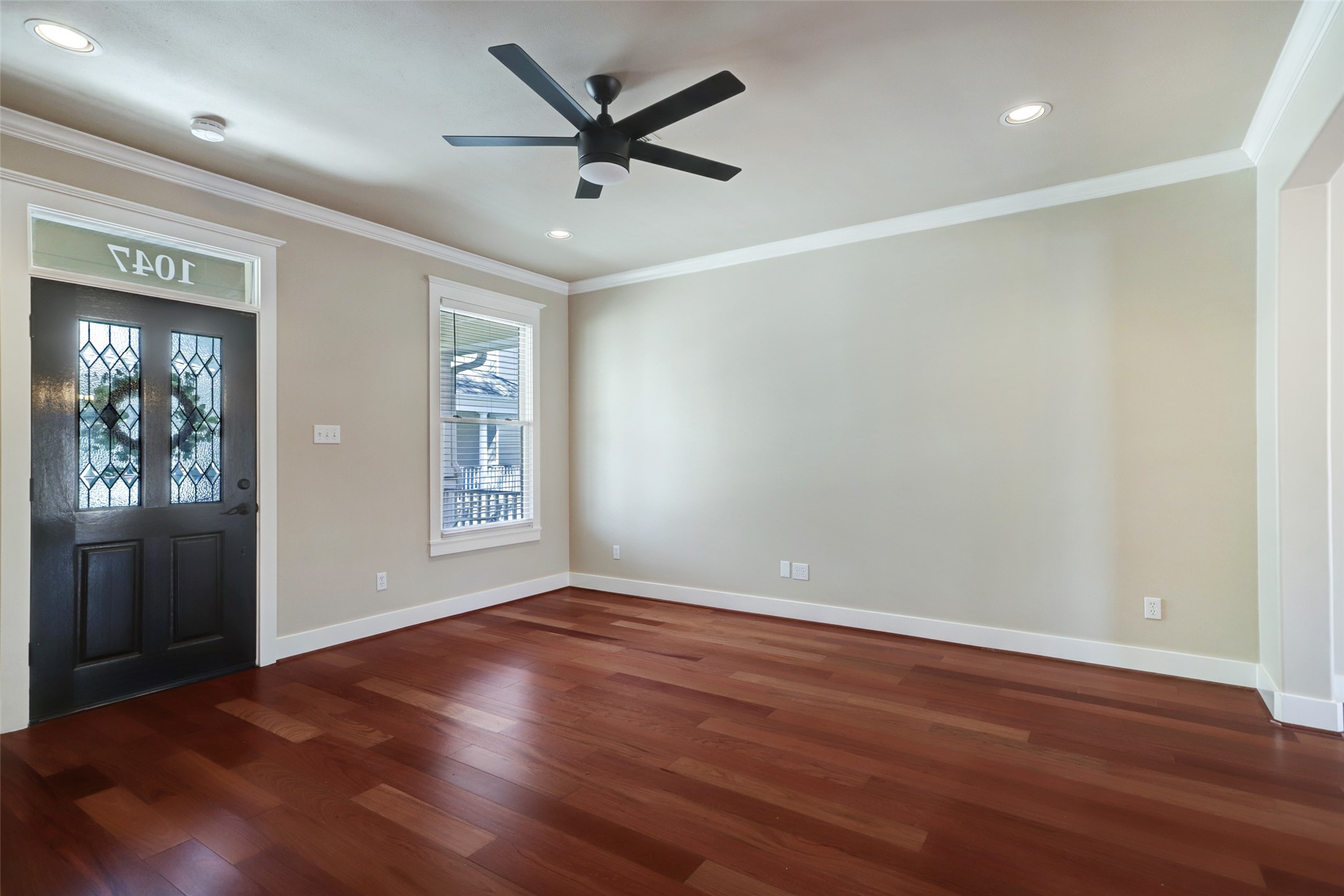 1047 West 16th Street Houston, TX 77008 - Photo 11 of 36 an empty room with wooden floor and windows