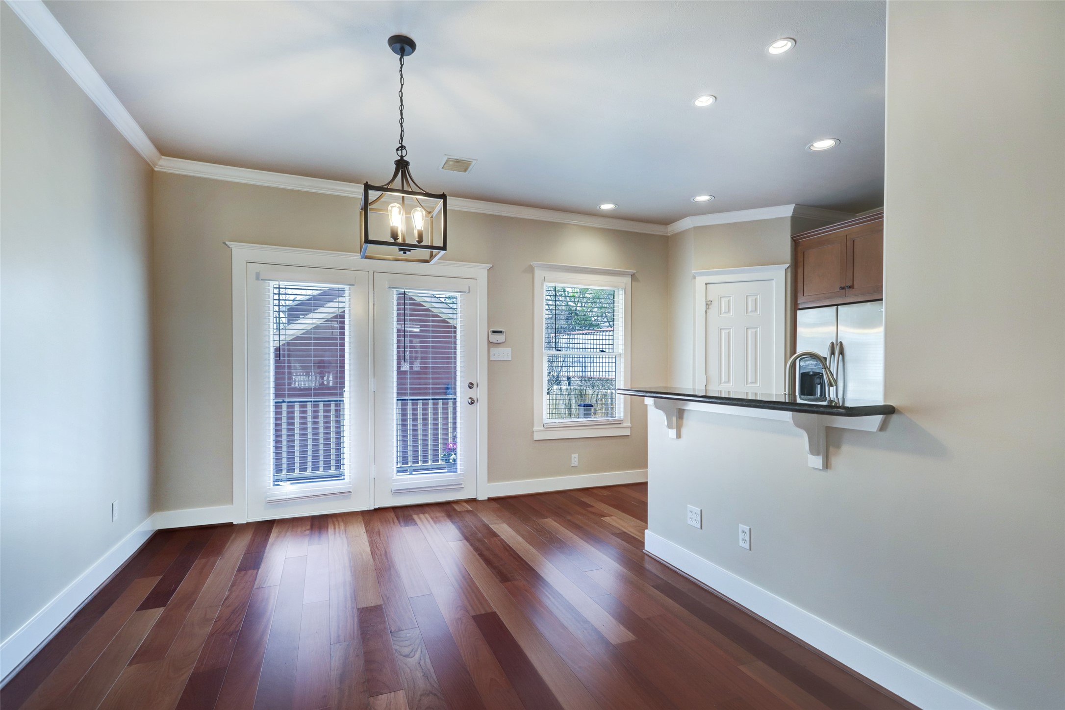 1047 West 16th Street Houston, TX 77008 - Photo 12 of 36 a view of a room with wooden floor a ceiling fan and windows
