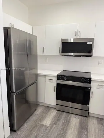 a kitchen with appliances and cabinets