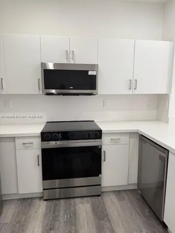 a kitchen with cabinets and steel stainless steel appliances