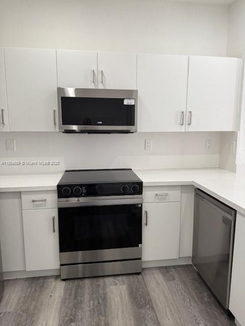 17820 Northwest 73rd Avenue, Unit 1011 Hialeah, FL 33015 - Photo 12 of 22 a kitchen with cabinets and steel stainless steel appliances