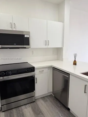 a kitchen with a stove and a microwave