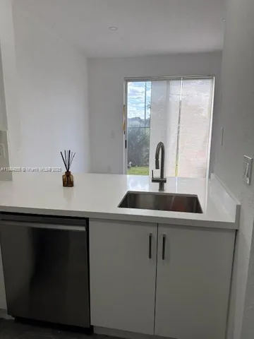 a kitchen with a sink and a window