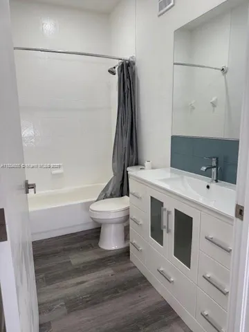 a bathroom with a sink a toilet and bathtub
