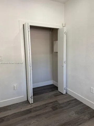 an empty room with wooden floor