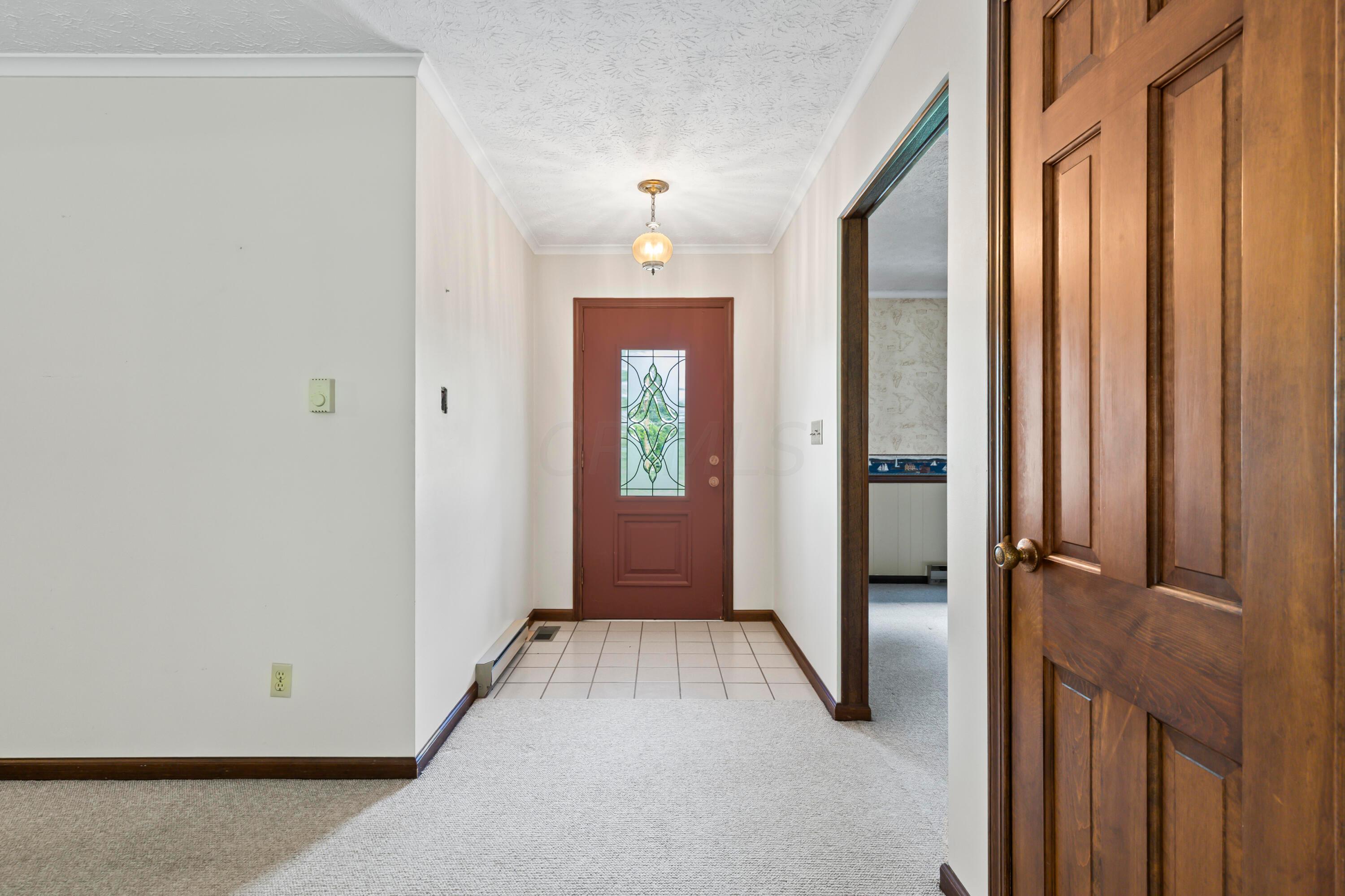 5764 Cheshire Road Galena, OH 43021 - Photo 3 of 59 • Ceramic tile flooring
• Tan painted walls
• Ceiling light